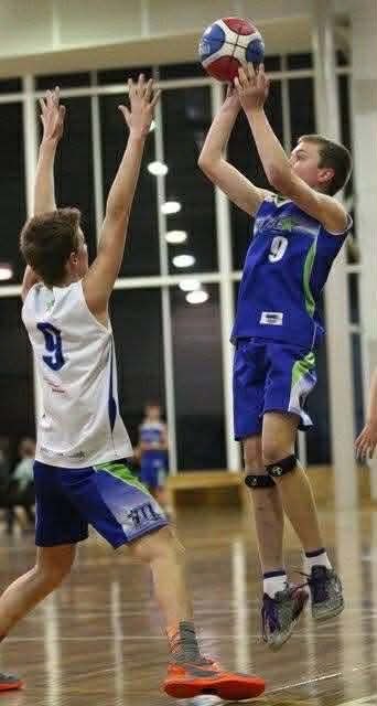 Cameron as a junior player, number 9, taking a jump shot