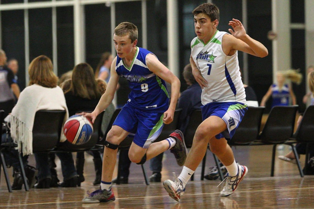 Cameron as a junior player, number 9, dribbling past a defender